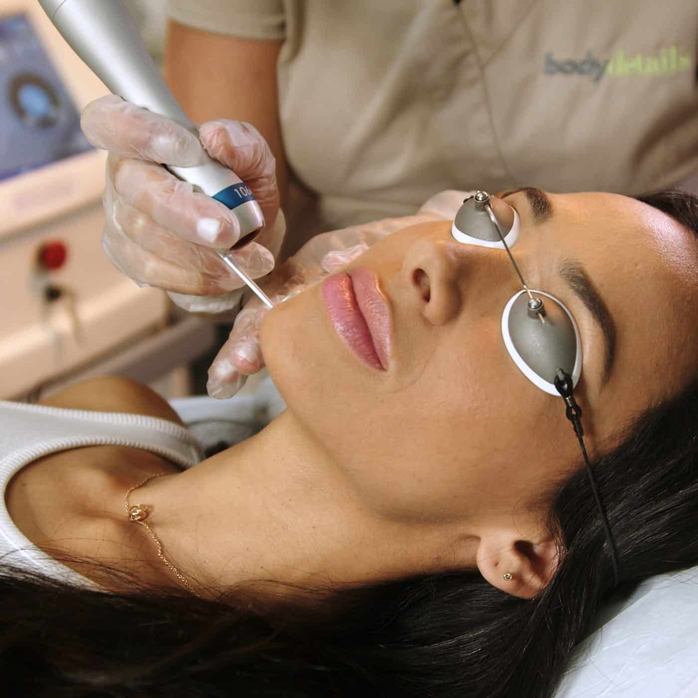 woman smiling during laser skin rejuvenation treatment