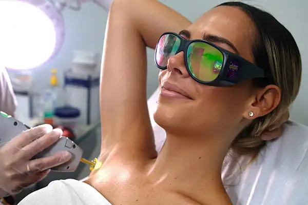 woman receiving laser hair removal under her arms